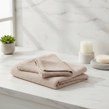 Folded beige towel on a light gray background