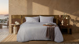 Cotton bed sheet set from the Core Collection featuring breathable cotton comfort, decorative cushion covers, and elegant everyday bedroom styling