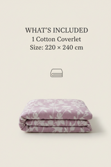 Folded purple cotton coverlet with floral pattern on a beige background