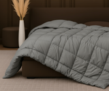 Hotel-quality cotton feather filled comforter from the Signature Collection styled in a luxury bedroom with soft layered bedding and elegant neutral décor