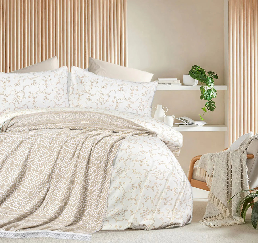 Neatly made bed with patterned bedding in a bedroom setting.
