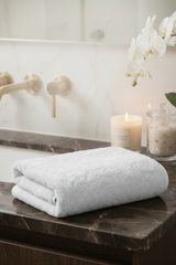 Folded white towel on a bathroom counter with features listed above.